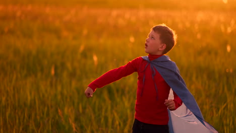 Boy-in-runs-in-a-red-raincoat-holding-a-plane-laughing-at-sunset-in-the-summer-field-imagining-that-he-is-an-airplane-pilot-playing-with-a-model-airplane